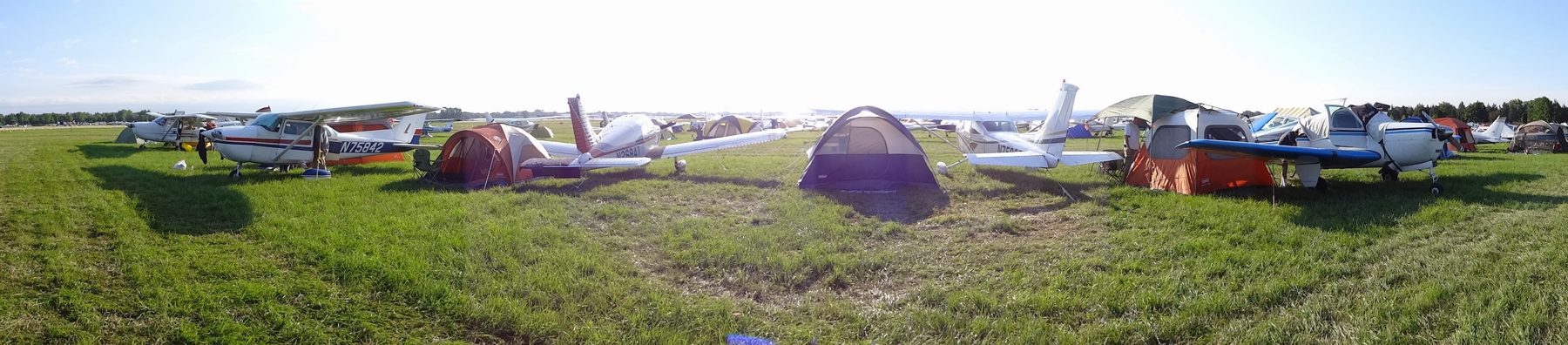 Panorama of airplanes and tents in the North 40 at Oshkosh